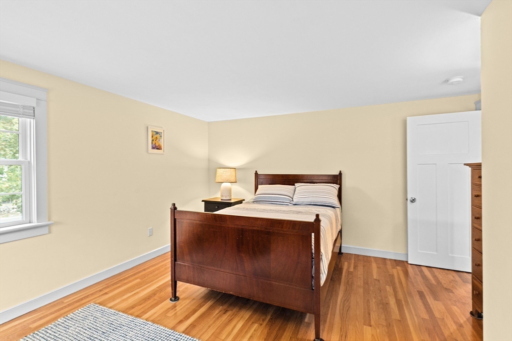 355 Tilden Road Scituate, MA 02066 - Photo 22 of 42 a bedroom with a bed and wooden floor