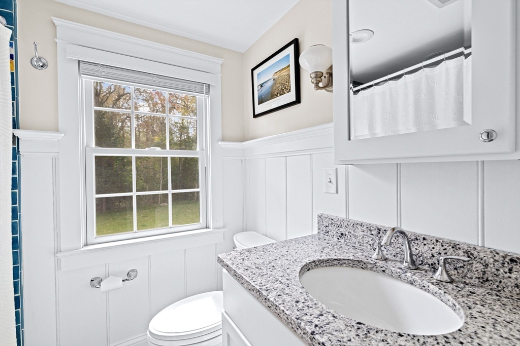 355 Tilden Road Scituate, MA 02066 - Photo 24 of 42 a bathroom with a granite countertop sink a mirror and a toilet