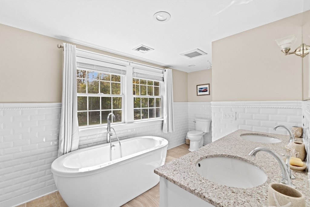 355 Tilden Road Scituate, MA 02066 - Photo 30 of 42 a white bath tub sitting next to a bathroom sink