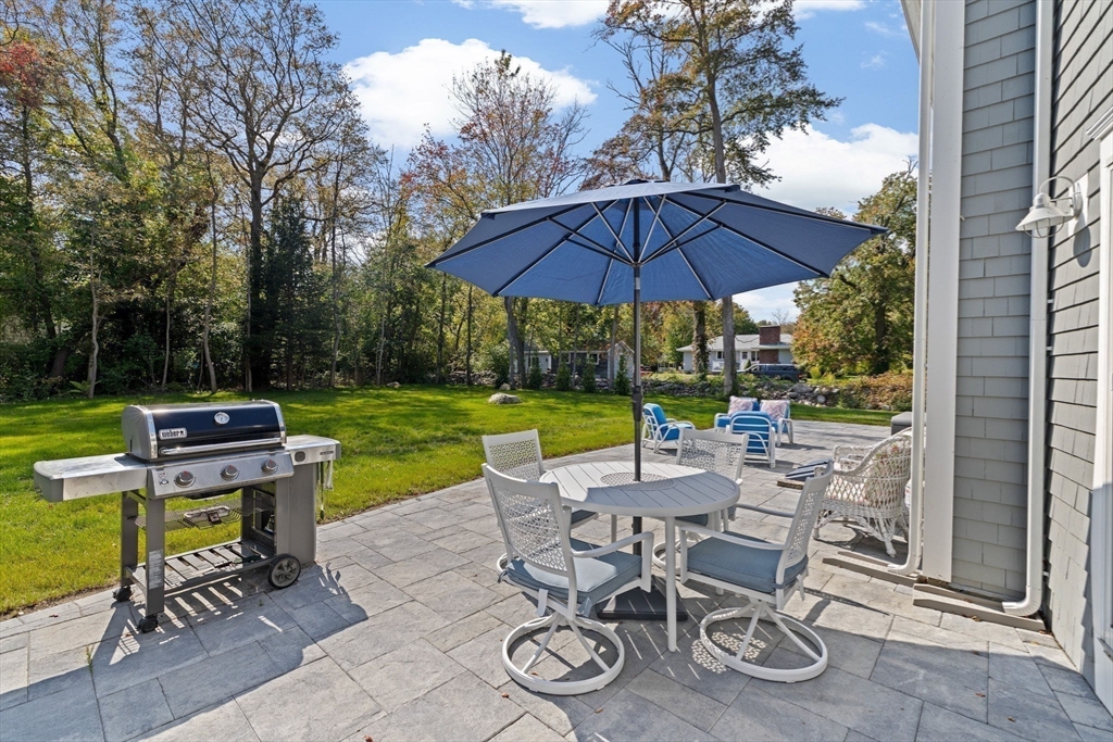 355 Tilden Road Scituate, MA 02066 - Photo 33 of 42 a view of a chairs and table under an umbrella in backyard
