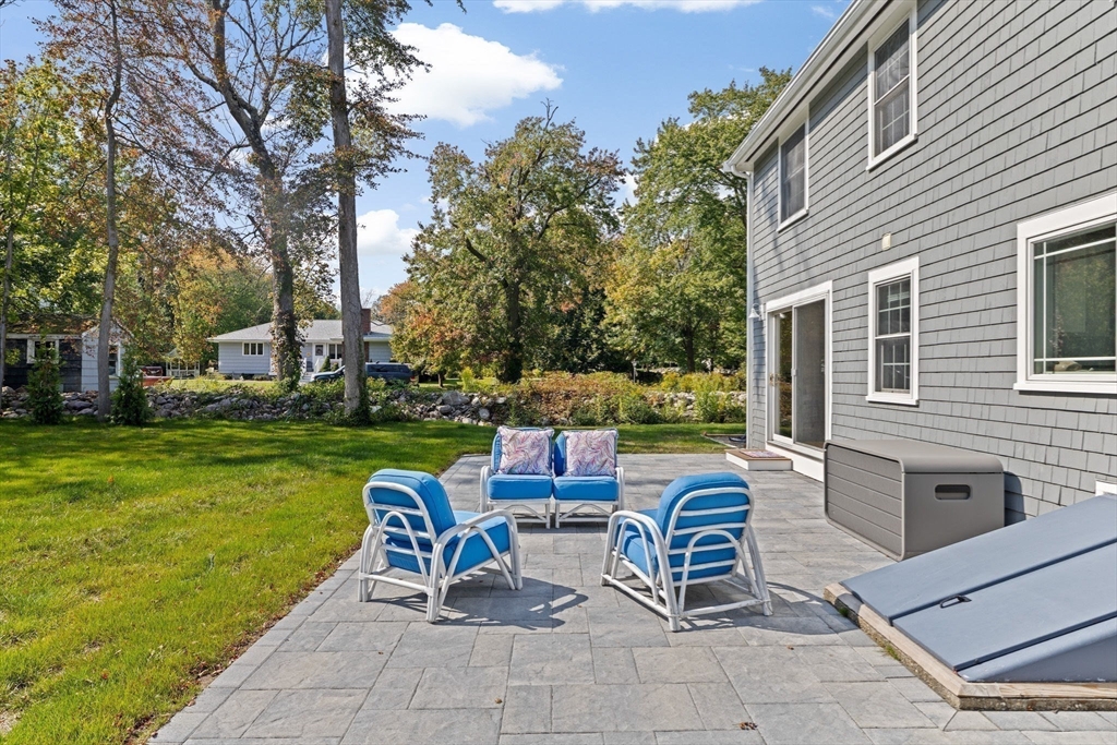 355 Tilden Road Scituate, MA 02066 - Photo 34 of 42 a view of a chairs and table in the back yard of the house