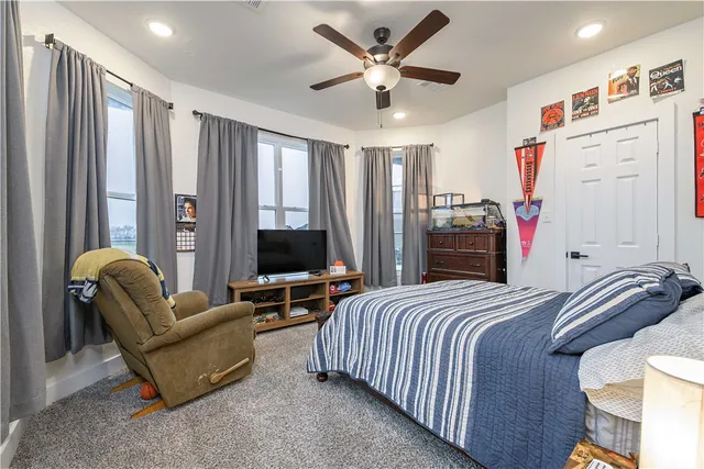 a bathroom with a toilet and a shower curtain