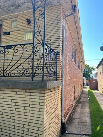 a brick building with a street sign on it