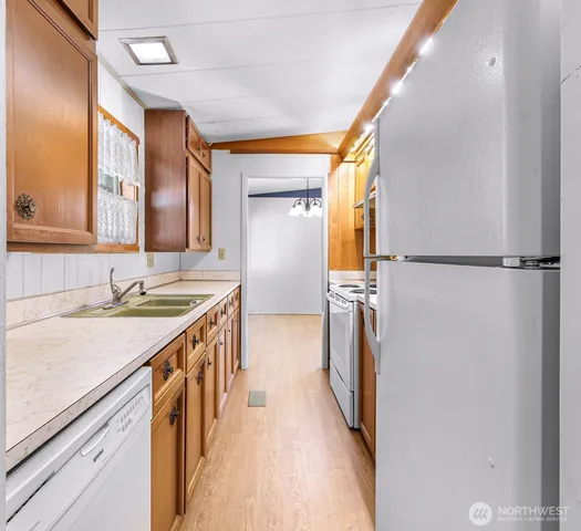 a kitchen with a sink and a refrigerator