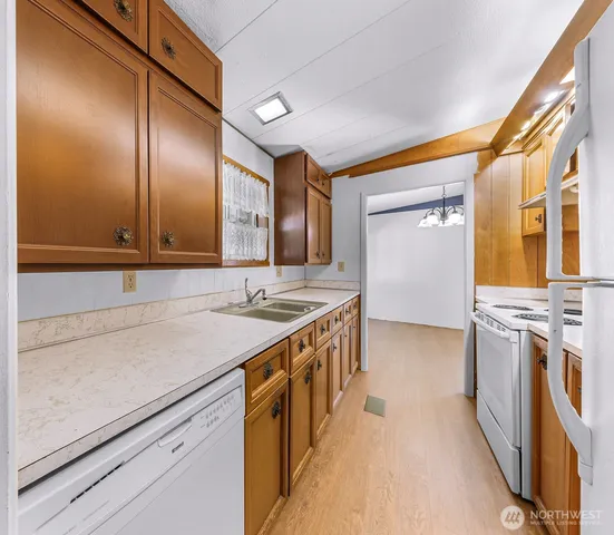 a kitchen with stainless steel appliances granite countertop a sink and a stove top oven