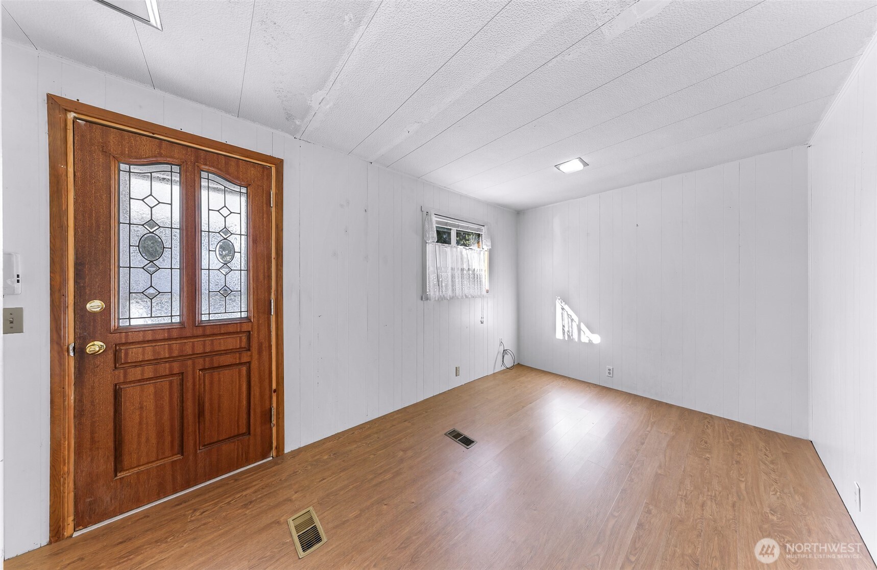 9403 Pierce Lane, Unit 1 Sedro-Woolley, WA 98284 - Photo 14 of 30 an empty room with wooden floor and windows