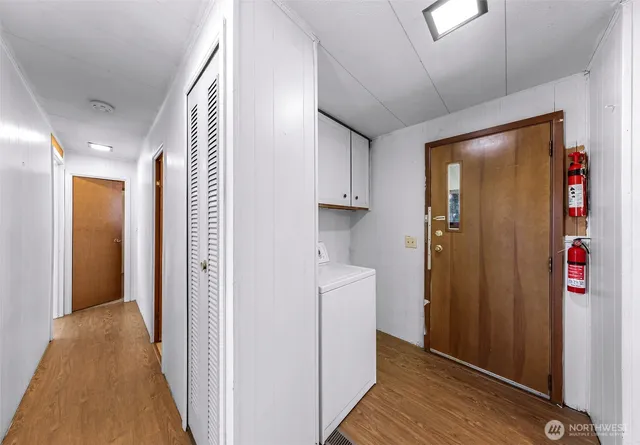 a view of hallway with wooden floor