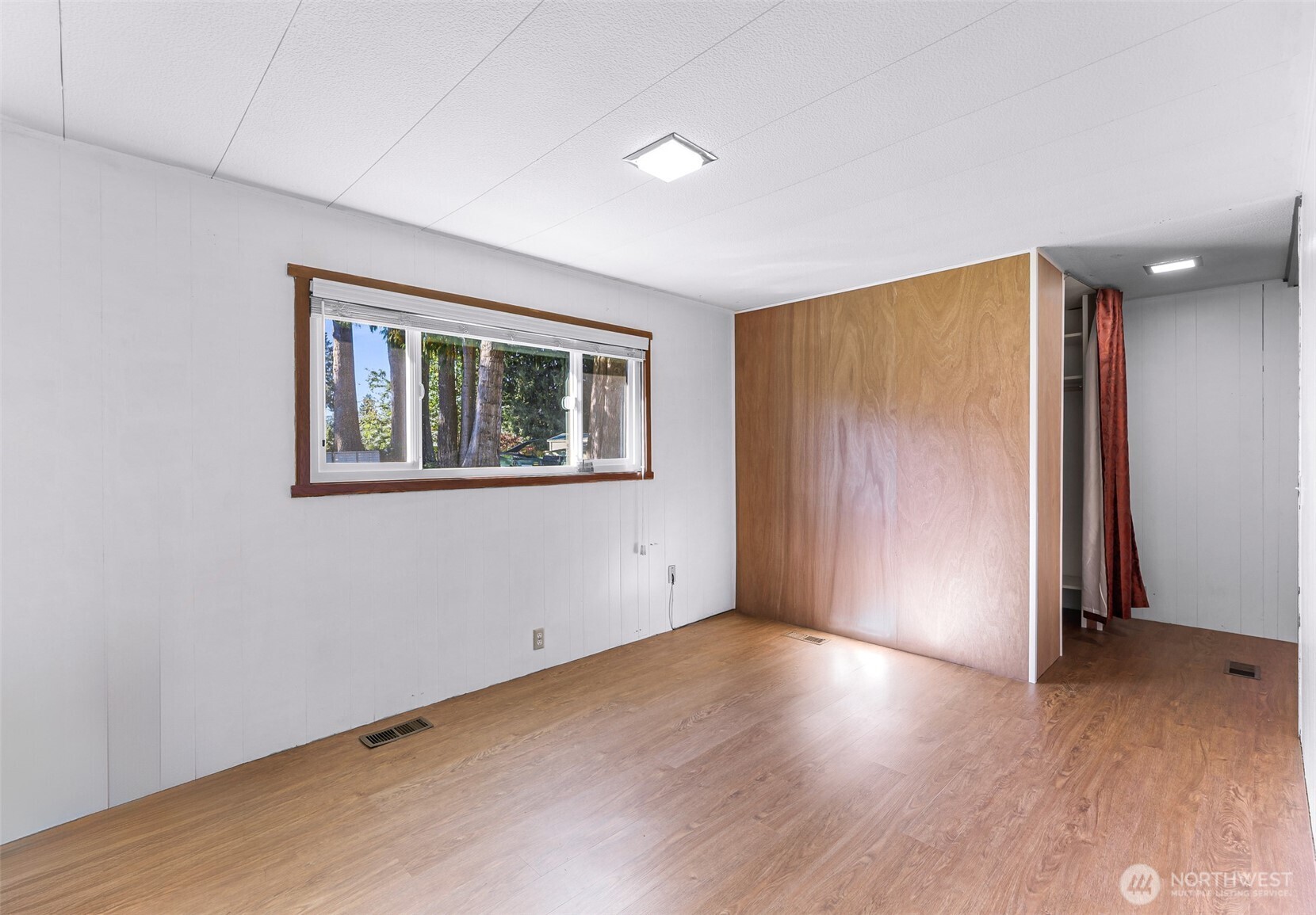 9403 Pierce Lane, Unit 1 Sedro-Woolley, WA 98284 - Photo 18 of 30 an empty room with wooden floor and windows