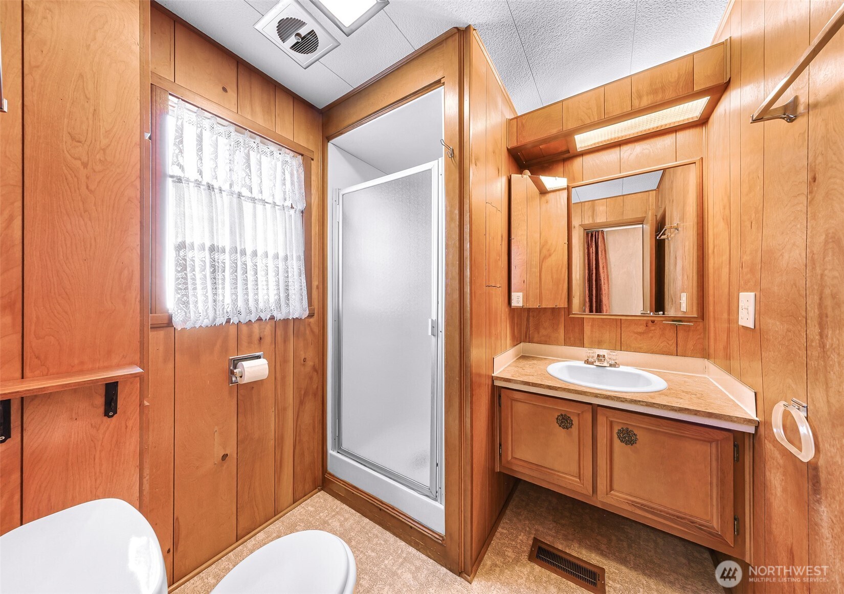 9403 Pierce Lane, Unit 1 Sedro-Woolley, WA 98284 - Photo 21 of 30 a bathroom with a toilet sink and mirror