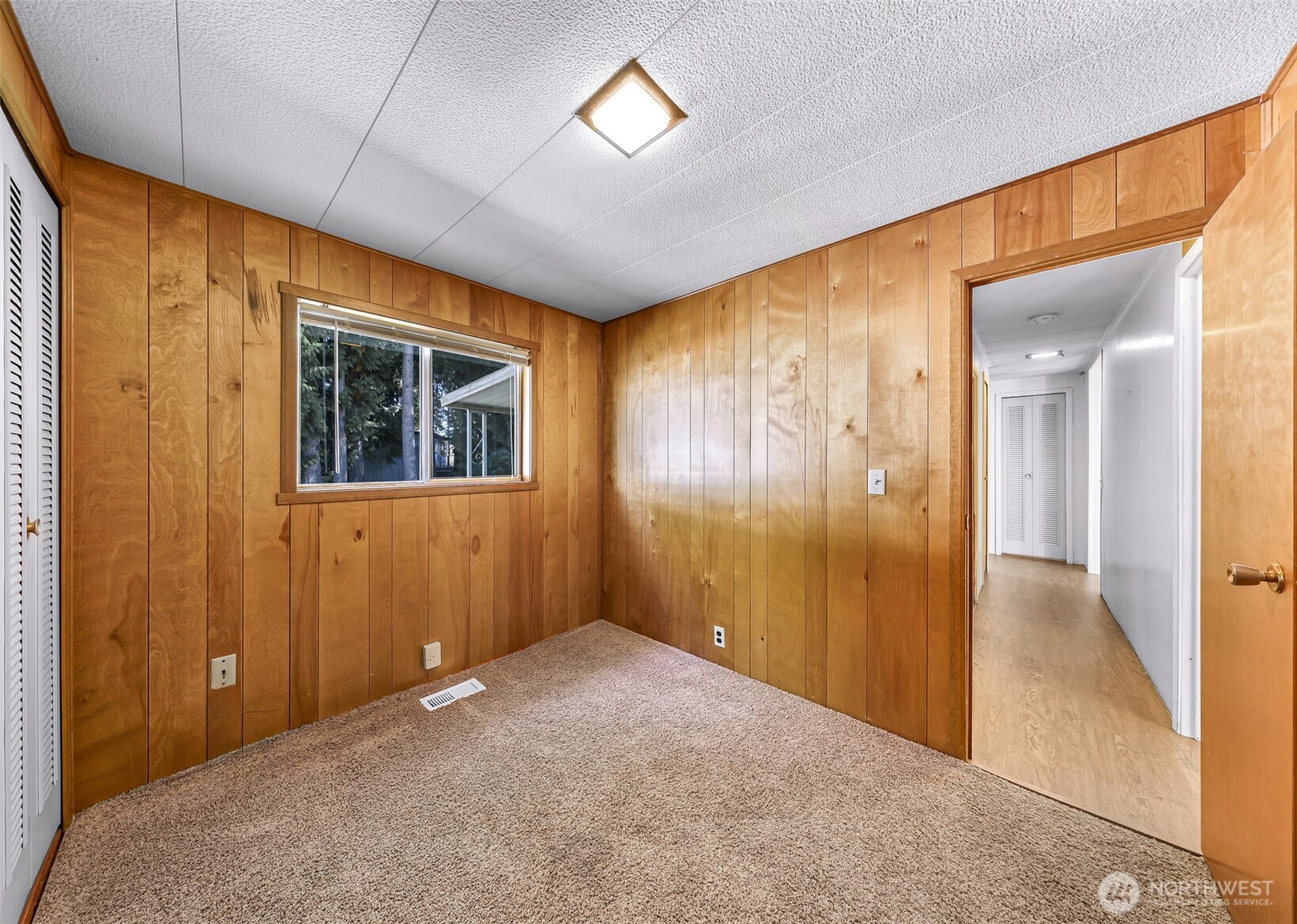 9403 Pierce Lane, Unit 1 Sedro-Woolley, WA 98284 - Photo 23 of 30 a view of a hallway with wooden shelves