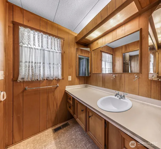 a bathroom with a sink double vanity and a mirror