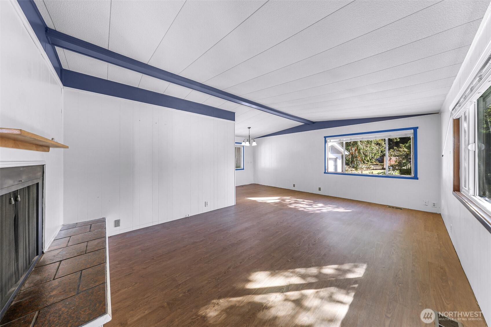 9403 Pierce Lane, Unit 1 Sedro-Woolley, WA 98284 - Photo 4 of 30 a view of an empty room with a window and wooden floor