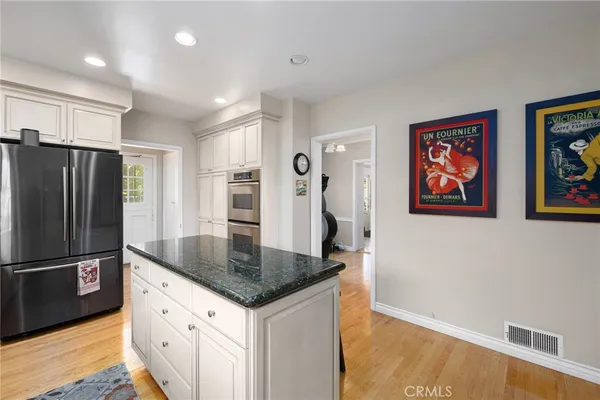 a view of a hallway with a livingroom and a bathroom with sink