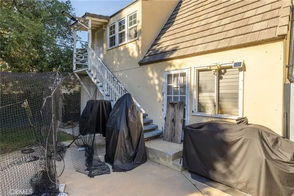 an aerial view of a house with a yard basket ball court and outdoor seating