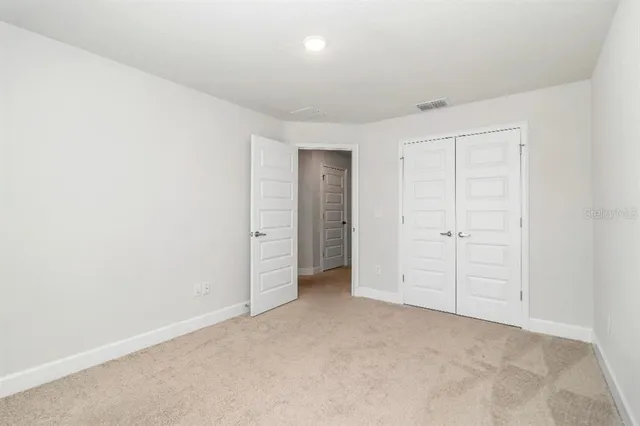 an empty room with closet area