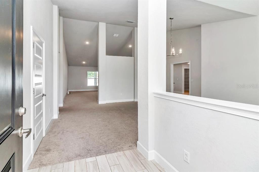 8376 Southwest 59th Terrace Ocala, FL 34476 - Photo 5 of 23 a view of a hallway with wooden floor