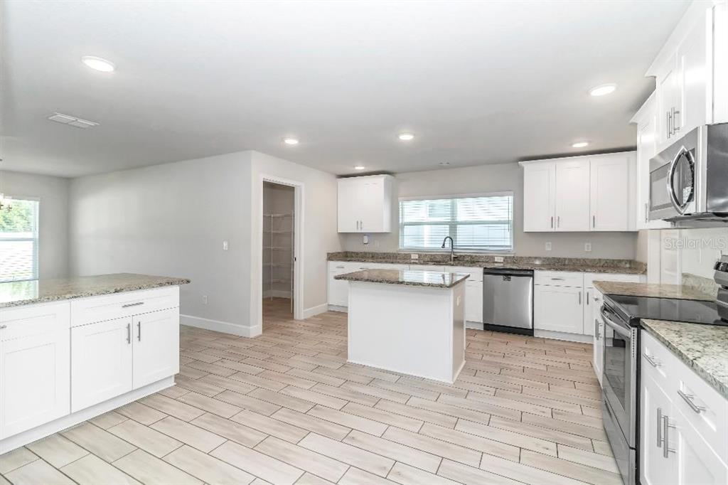 8376 Southwest 59th Terrace Ocala, FL 34476 - Photo 10 of 23 a kitchen with a sink window and cabinets