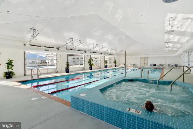 a kitchen with stainless steel appliances granite countertop a refrigerator a stove a sink and a microwave