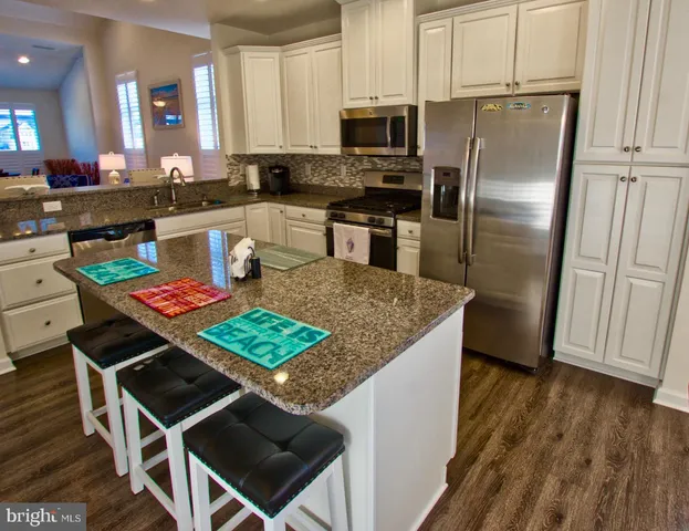 a living room with furniture a table and a chandelier