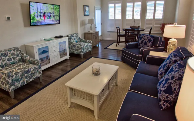 a view of a lake with a yard and large trees