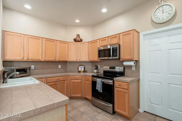a kitchen with a stove and cabinets