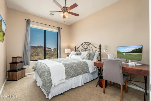 a view of a livingroom with furniture and a ceiling fan