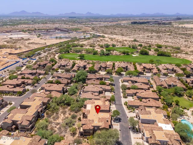 a view of a swimming pool with a yard and plants