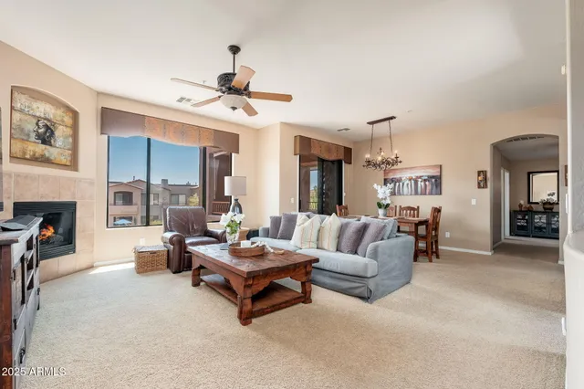 a living room with furniture a fireplace and a flat screen tv