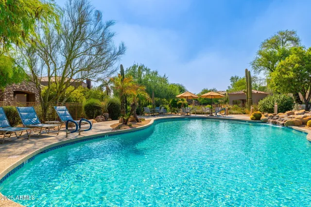 a view of a swimming pool and lounge chair