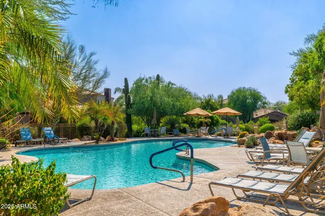 a view of a patio with chairs and table