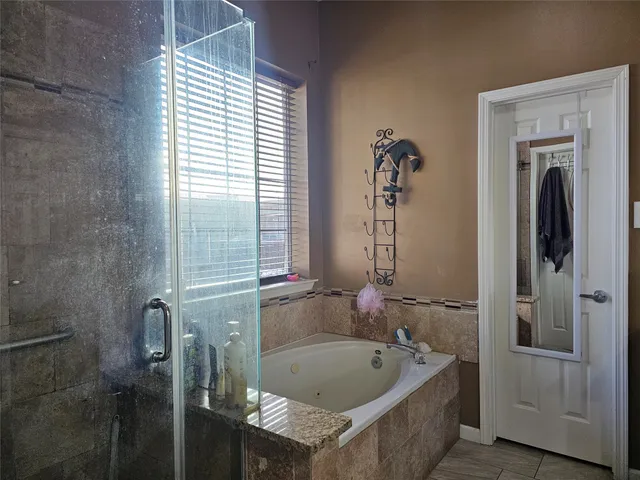 a bathroom with a tub and a shower