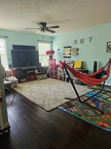 a living room with lots of furniture and a flat screen tv