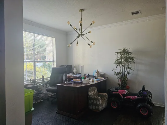 a dining room with furniture and a potted plant