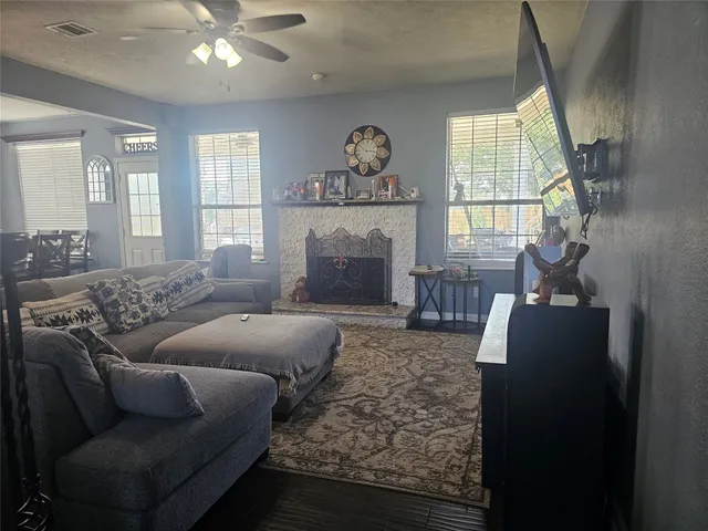 a living room with furniture and a fireplace