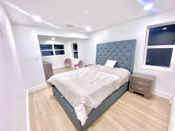a bedroom with a bed and a flat screen tv