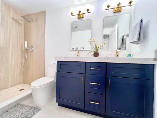 a bathroom with a toilet a sink and a mirror