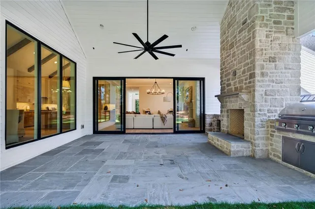 a view of a livingroom with a fireplace and window