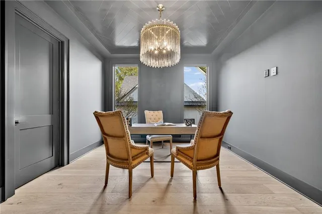 a view of a dining room with furniture and a chandelier