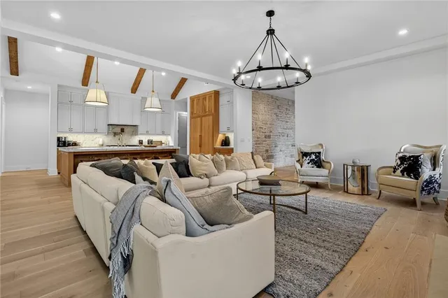 a living room with furniture wooden floor and a chandelier