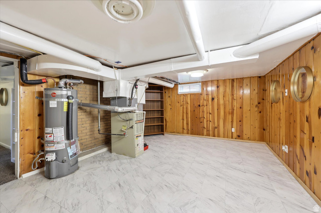 676 South 500 West Provo, UT 84601 - Photo 23 of 29 Finished basement featuring wood walls, secured water heater, and heating unit