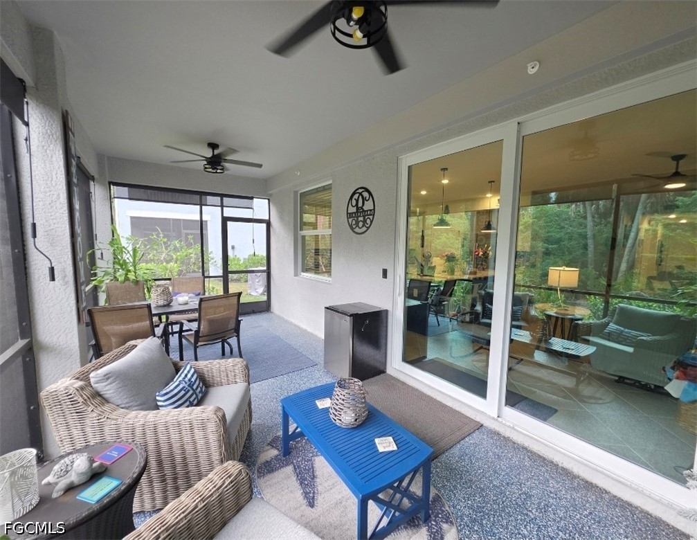 14191 Poppy Fld Loop, Unit 5312 Punta Gorda, FL 33955 - Photo 27 of 41 a living room with furniture and a floor to ceiling window