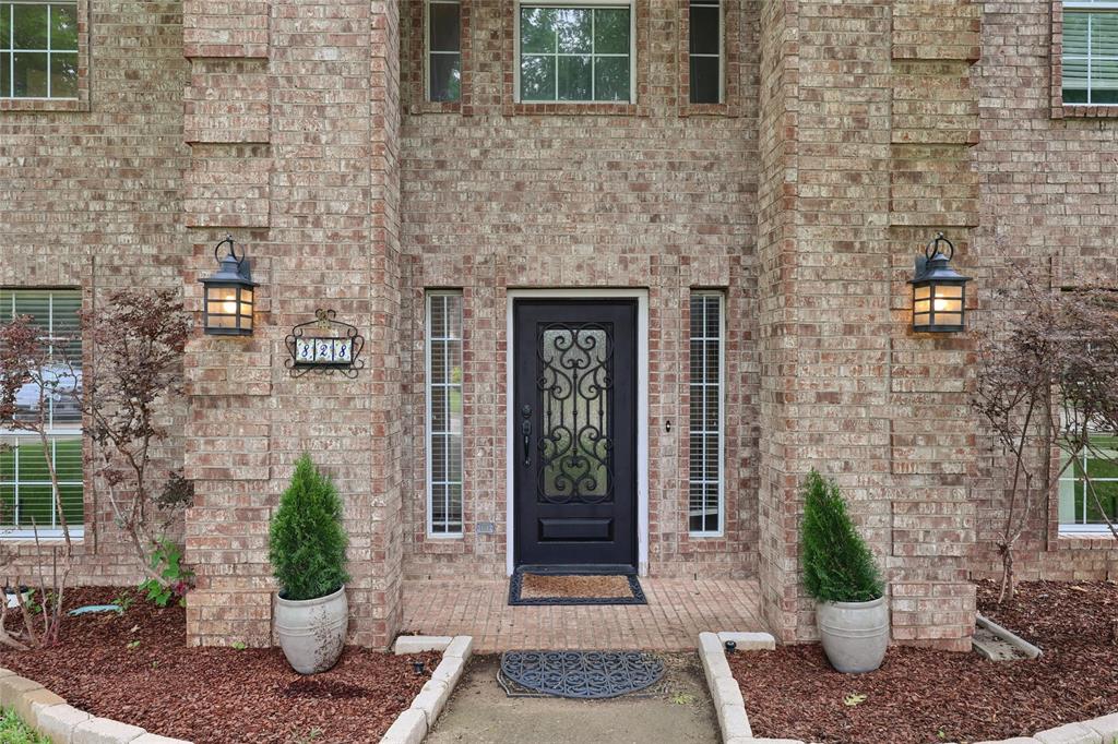 a view of a brick house with potted plants