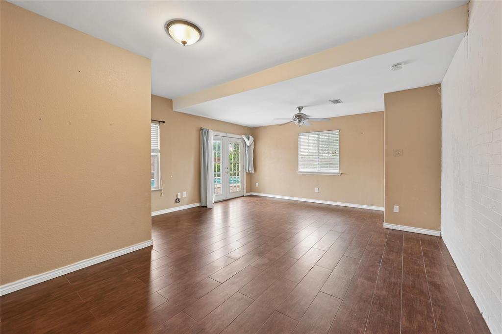 828 Rockefeller Lane Allen, TX 75002 - Photo 12 of 31 an empty room with wooden floor and windows