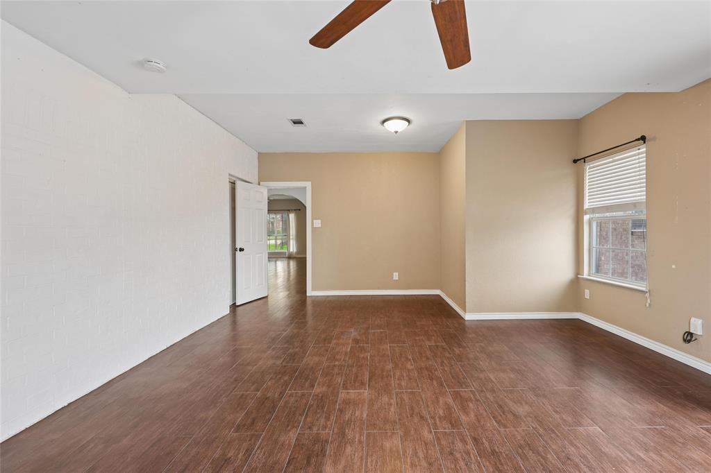 828 Rockefeller Lane Allen, TX 75002 - Photo 13 of 31 an empty room with wooden floor and windows
