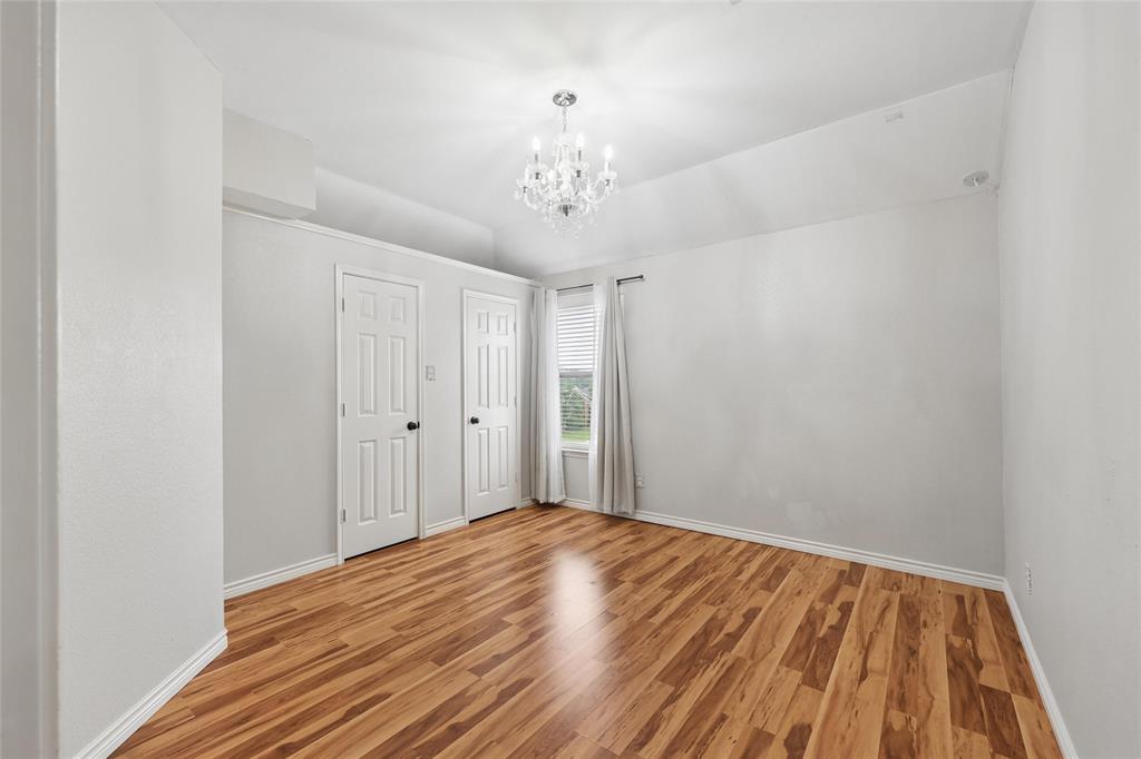 828 Rockefeller Lane Allen, TX 75002 - Photo 14 of 31 a view of a room with wooden floor and chandelier