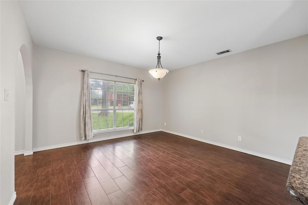 828 Rockefeller Lane Allen, TX 75002 - Photo 15 of 31 a view of an empty room with wooden floor and a window