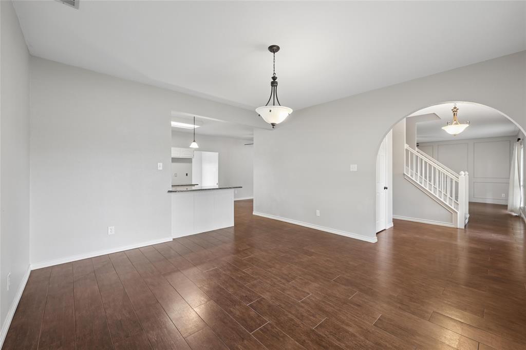 828 Rockefeller Lane Allen, TX 75002 - Photo 7 of 31 a view of a kitchen with wooden floor and a ceiling fan