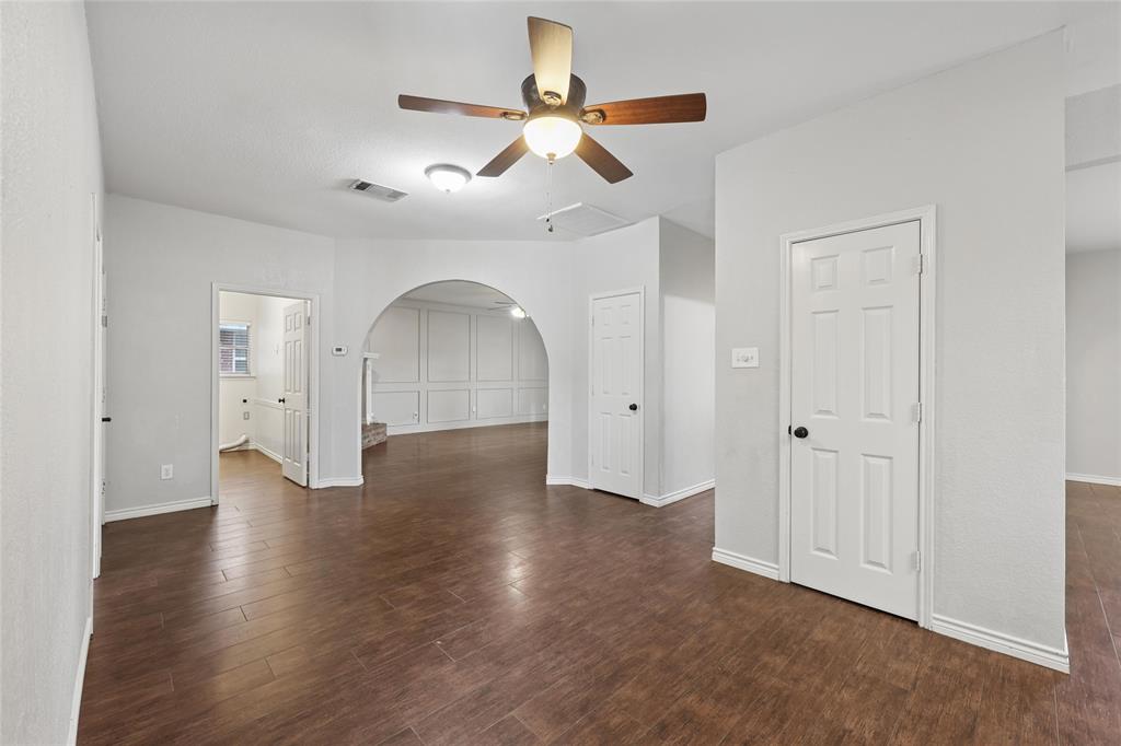 828 Rockefeller Lane Allen, TX 75002 - Photo 8 of 31 an empty room with wooden floor ceiling fan and windows