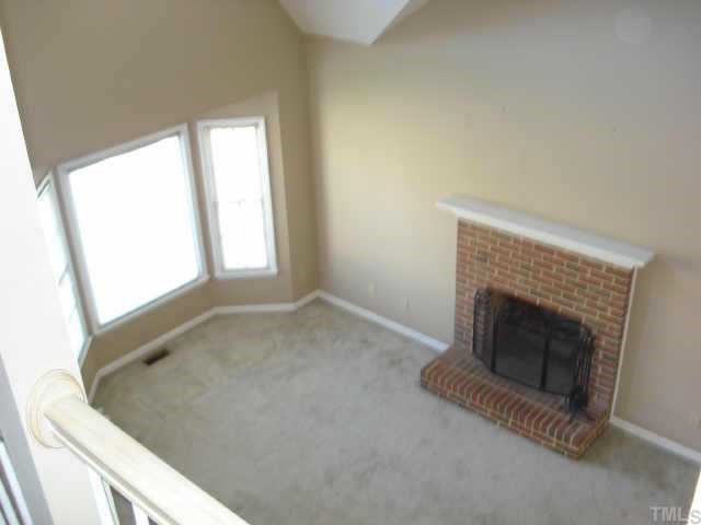 4500 Emmit Drive Raleigh, NC 27604 - Photo 5 of 10 an empty room with a fireplace