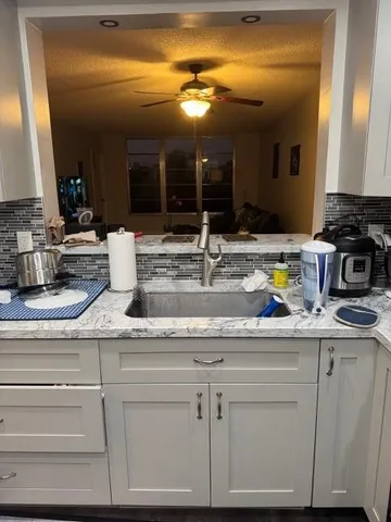 a kitchen with cabinets appliances and a counter
